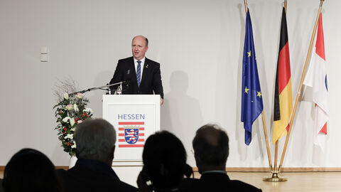 Grußwort des Hessischen Europastaatssekretärs Uwe Becker. Uwe Becker steht am Rednerpult und spricht.