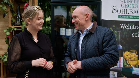 Die Rheingauer Weinkönigin Viktoria Wolf und Staatsminister Manfred Pentz schlenderten gemeinsam von Stand zu Stand Weinkönigin und Minister lächelnd im Gespräch miteinander: Die Rheingauer Weinkönigin Viktoria Wolf und Staatsminister Manfred Pentz schlenderten gemeinsam von Stand zu Stand